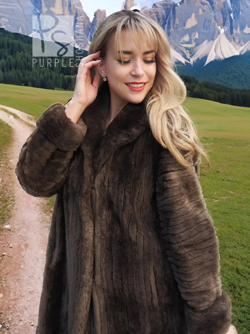 Dark brown plush fur coat with pointed collar and long sleeves, close-up