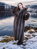 Long hooded fur coat with dark brown body and large fur cuffs; open front style.