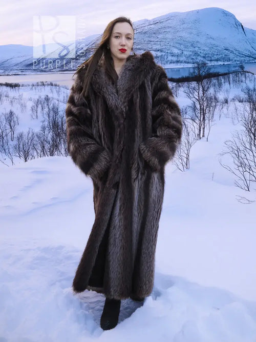 Long dark brown hooded fur coat with textured fur panels and full sleeves.