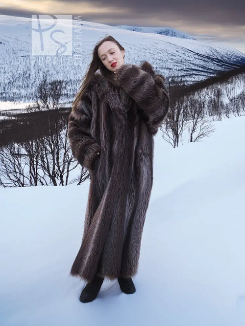 Long dark brown hooded fur coat with full sleeves and open front, angled view.