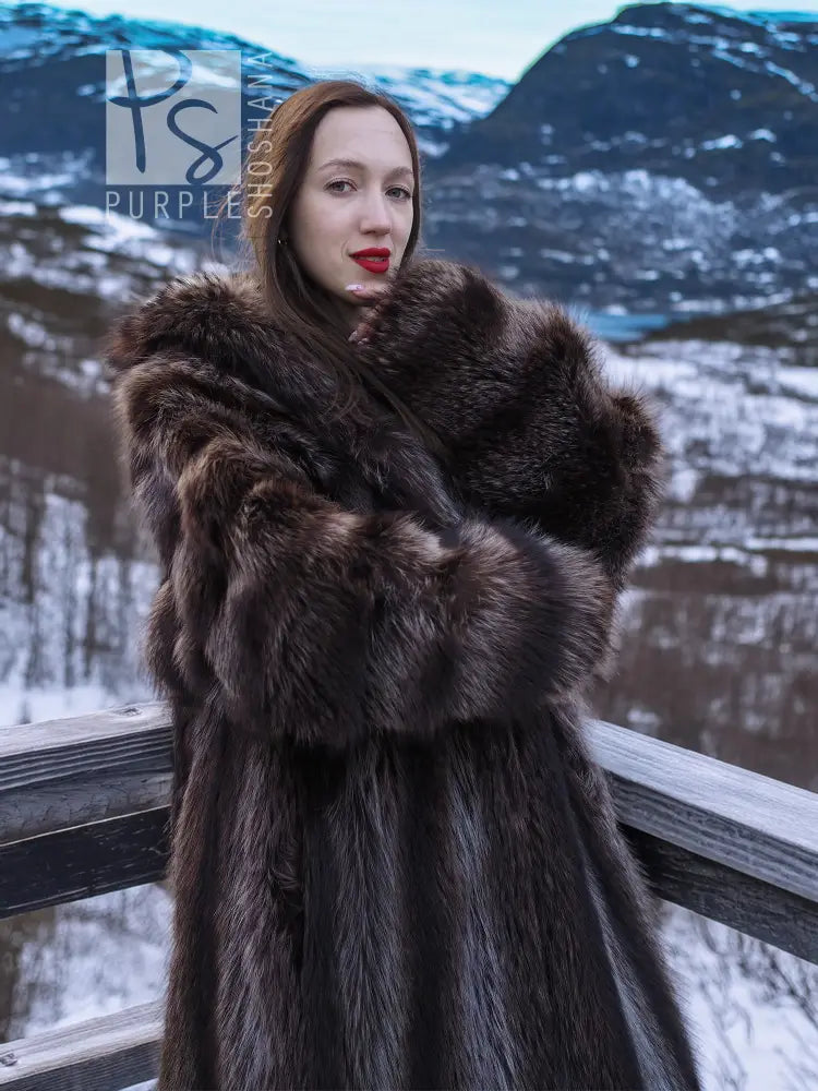 Close-up hooded fur coat with thick dark collar framing the face and neck.