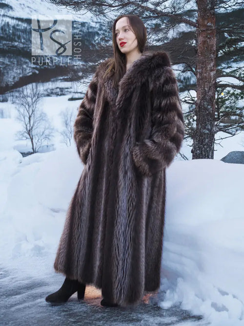 Long hooded dark brown fur coat with thick collar and full-length silhouette.