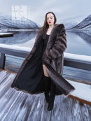 Long hooded fur coat with dark brown collar and relaxed open front; draped sides.