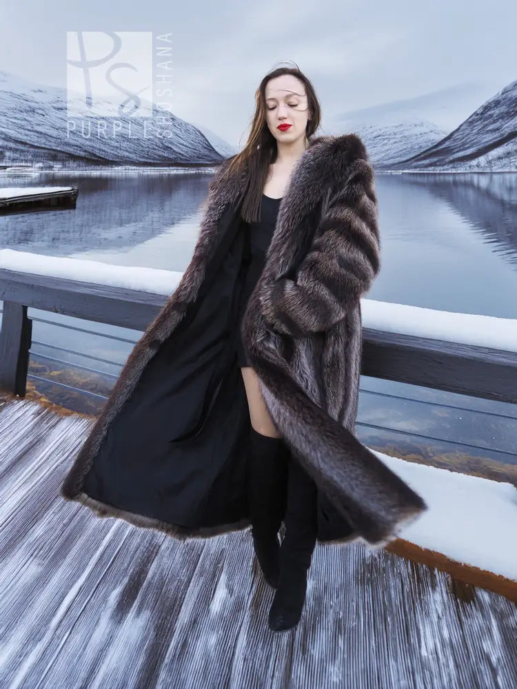 Long hooded fur coat with dark brown collar and relaxed open front; draped sides.