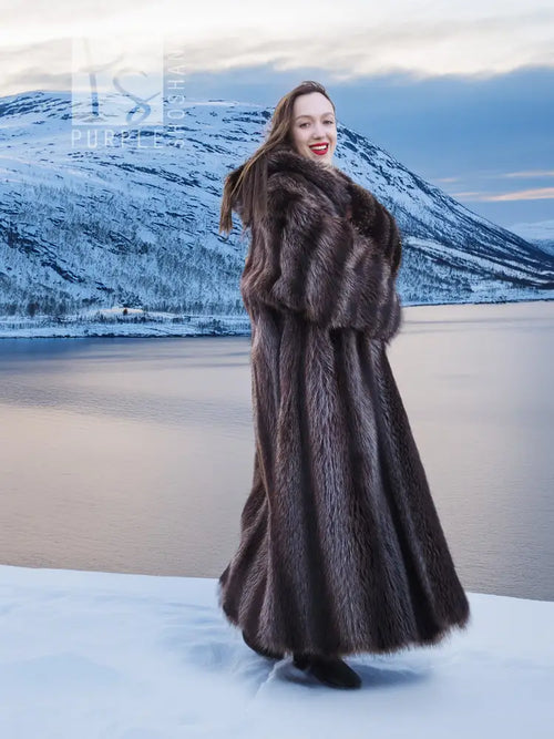 Long dark brown hooded fur coat, side view showing flared hem and drape.