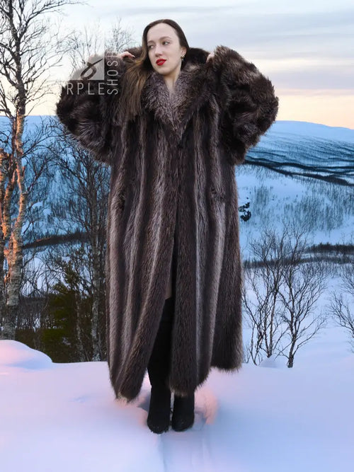 Long hooded dark brown fur coat with full sleeves and plush collar detail.