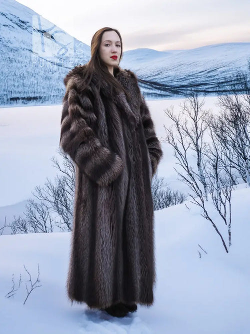 Long dark brown hooded fur coat with full-length sleeves and open front.