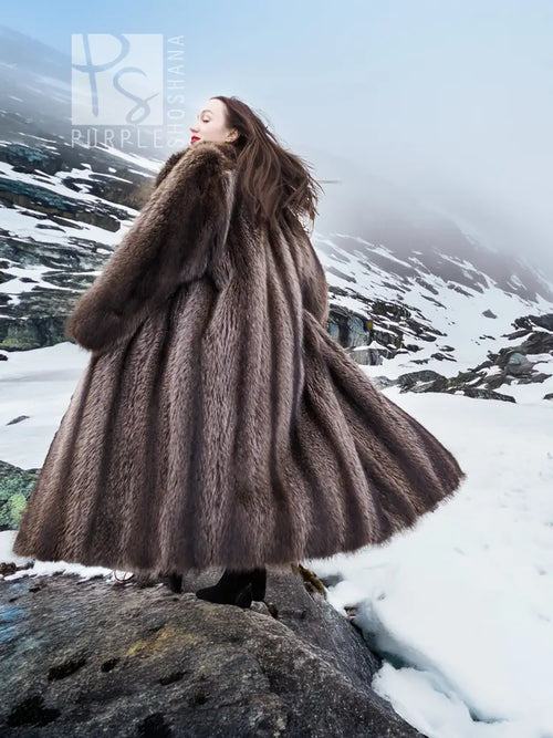 Flared long raccoon fur coat with high collar and dark brown shaggy texture