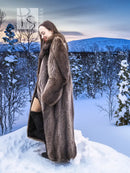 Long raccoon fur coat in side profile with stand collar and dark brown textured finish