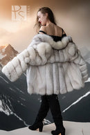 Cream fur jacket with wide off-shoulder neckline detail, plush sleeves, and straight front