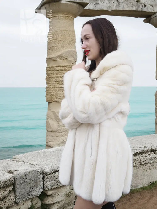 Women’s mink fur hooded coat, light beige, side view with belt-like waist seam
