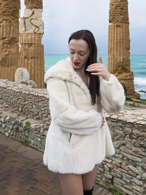 Women’s mink fur hooded coat, light beige, close side view with gathered waist shape