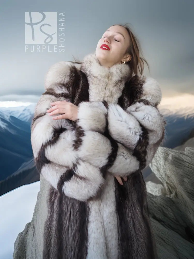 Full-length raccoon fur coat with fox-trim cuffs and bold black-and-white stripe pattern