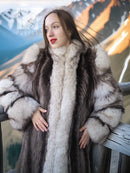 Front view of long striped fur coat with fox-trim collar, dark panels and pale fur