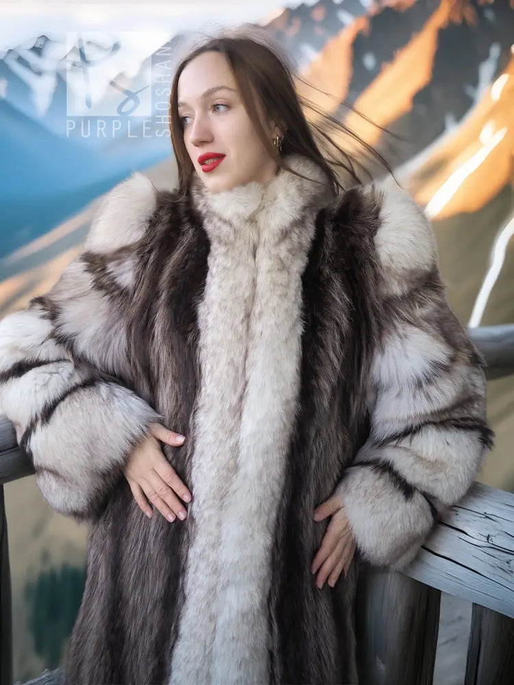 Front view of long striped fur coat with fox-trim collar, dark panels and pale fur