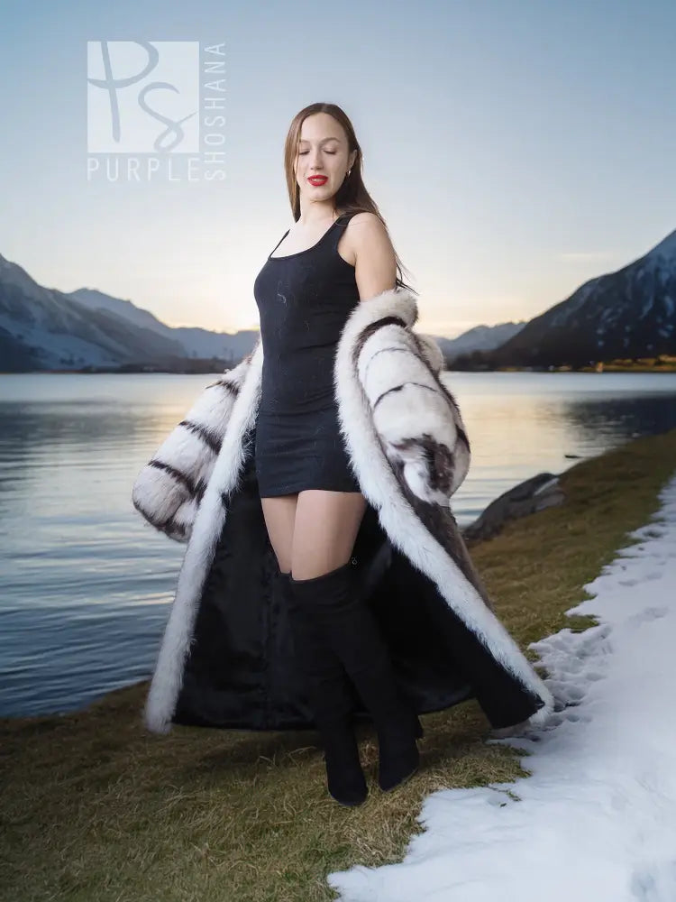 Full-length fur coat with striped white-and-dark fur panels and draped sleeves