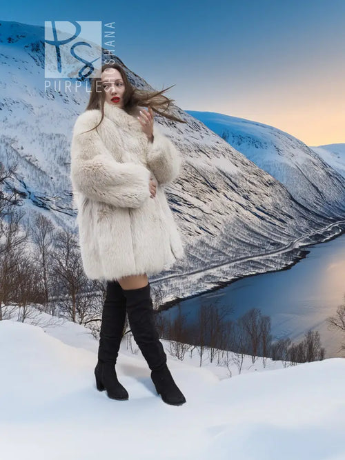 Soft Plush Blush Fox Jacket S/M featured in a snowy mountain scene, emphasizing its full fur texture and luxurious winter appeal.
