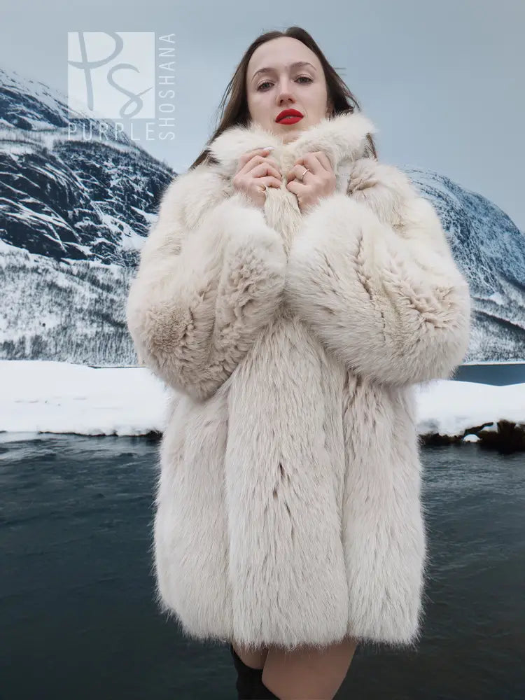 Soft plush fur jacket with stand collar and thick textured fur finish.