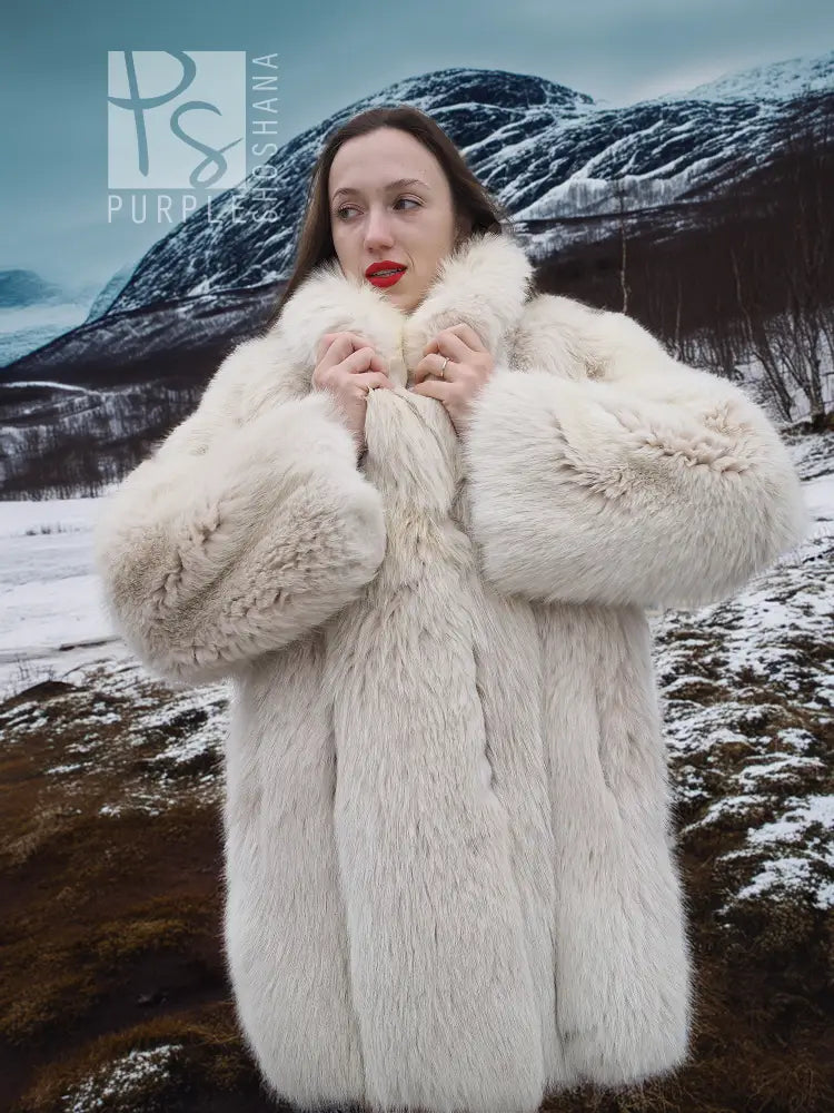 Soft plush fur jacket with stand collar and textured fur cuffs.