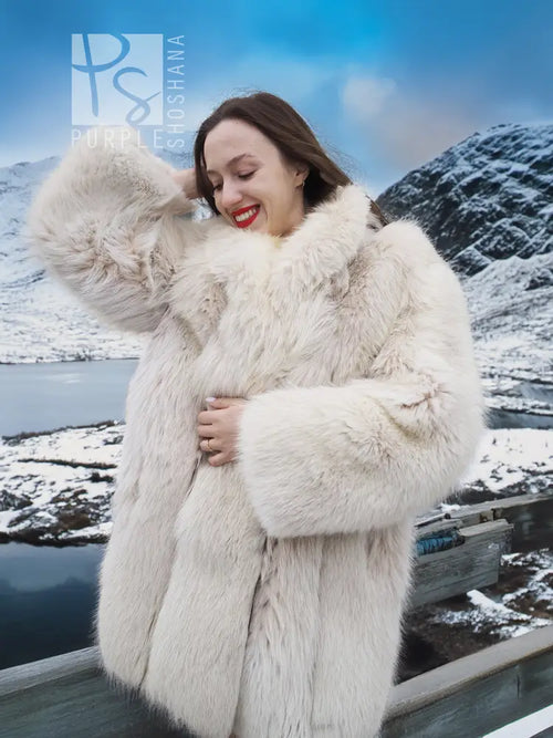 Soft plush fur jacket with full sleeves and stand collar, open front.