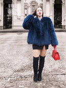 Vibrant blue faux fur jacket, fluffy short style with long sleeves, front view