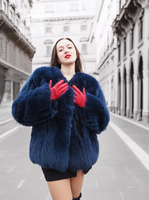 Vibrant blue faux fur jacket with shaggy texture and long sleeves, close front view