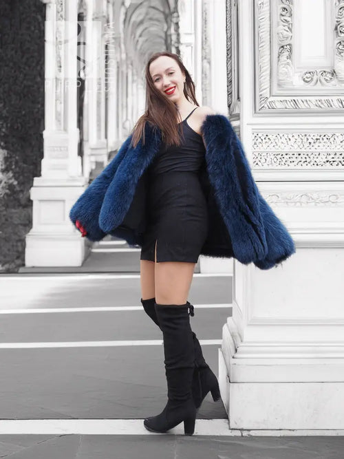 Blue faux fur jacket with short length, wide sleeves, and open front