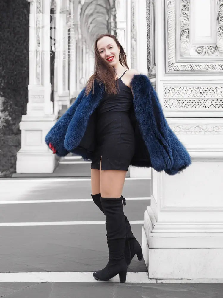 Blue faux fur jacket with short length, wide sleeves, and open front