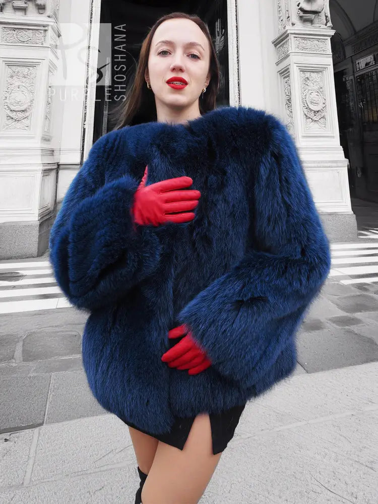 Blue faux fur jacket with plush texture and red gloves