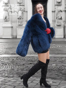 Blue faux fur jacket, cropped with voluminous sleeves and red cuff detail