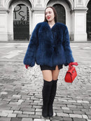 Blue fox-fur hooded jacket with full sleeves, short length, and fuzzy collar.