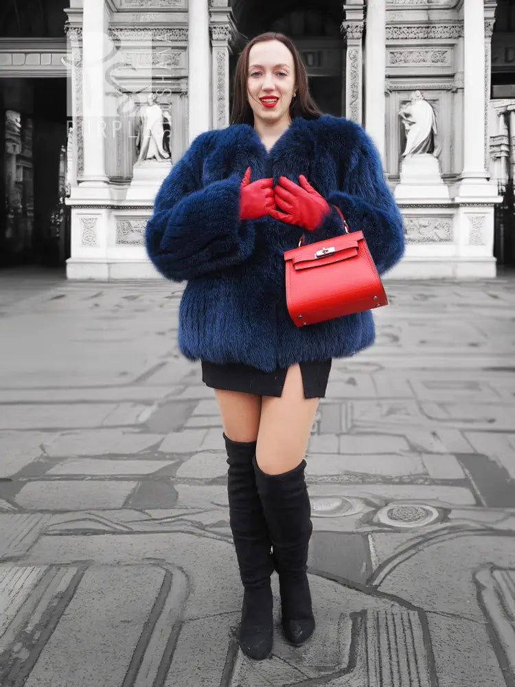 Blue fox-fur jacket with oversized hood and wide sleeves, short length.