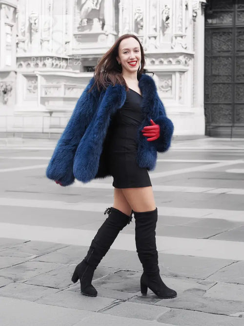 Vibrant blue faux fur jacket with open front and shaggy texture, long sleeves