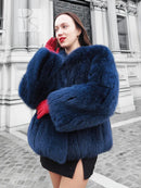 Blue fox-fur jacket with thick collar and hood, long sleeves, and short hem.