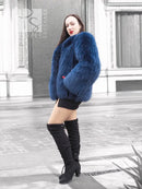 Blue fox-fur hooded jacket with long sleeves and cropped, flared shape at hem.