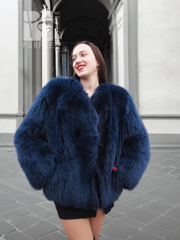 Vibrant blue faux fur jacket with plush collar and long sleeves, front view