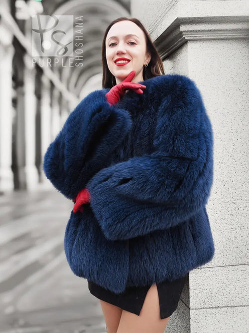 Blue fox-fur jacket with hood and thick collar, long sleeves with ribbed cuffs.