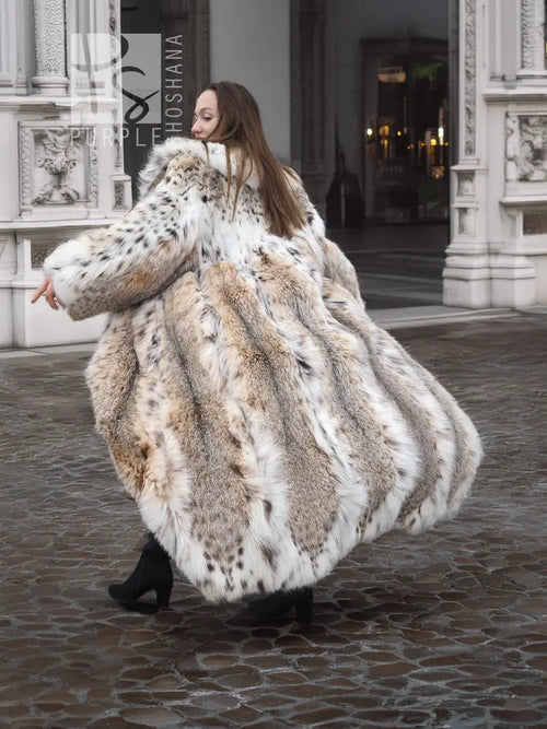 Spotted plush fur coat with shawl collar, wide flowing skirt, beige base with dark speckling