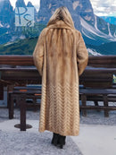 Back view of tan mink fur coat with hood and herringbone pattern at the hem.