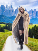 Long tan mink fur coat with chevron pattern, open front and wide collar.