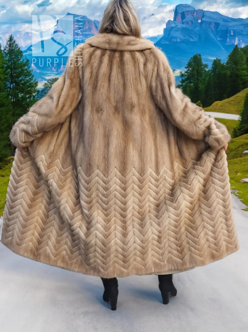 Hooded tan mink fur coat with wide flared skirt and herringbone pattern on the back.