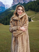 Pastel tan mink fur coat with hood, toggle closure, and herringbone patterned body.