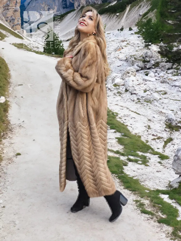Tan hooded mink fur coat with long length and herringbone chevron texture