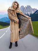 Long tan mink fur coat with chevron pattern and wide draped back panel.