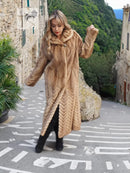 Long tan mink fur coat with hood, chevron/herringbone pattern and button-front closure.
