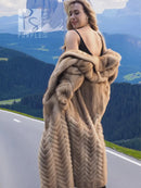 Tan mink fur hooded coat with herringbone pattern, worn over a dark sleeveless dress.