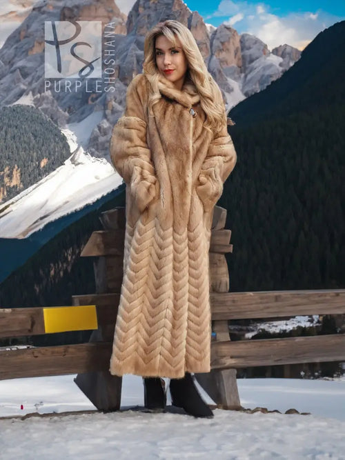 Long tan mink fur coat with hood, chevron/herringbone pattern, single front button.