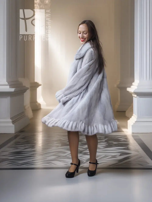 Light gray mink coat with petal collar and sculpted ruffled hem, full length front view