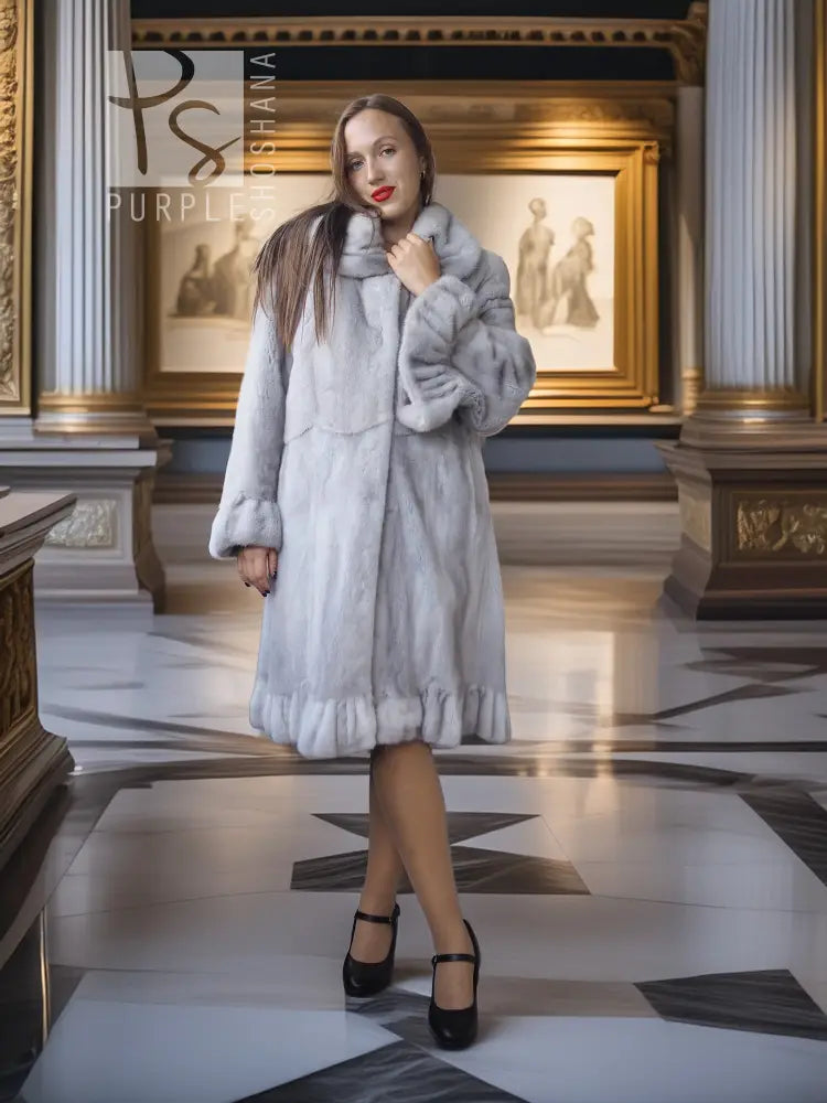 Light gray mink coat with petal collar and sculpted hem, worn front-facing with black heels.