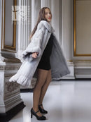 Light gray mink coat with petal collar and sculpted ruffled hem, side view
